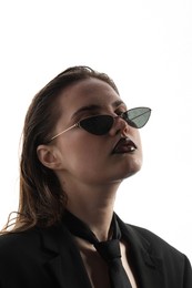 Photo of Beautiful young woman with black lip liner wearing wet sunglasses on white background