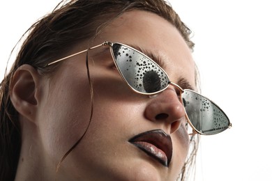 Photo of Beautiful young woman with black lip liner wearing wet sunglasses on white background, closeup