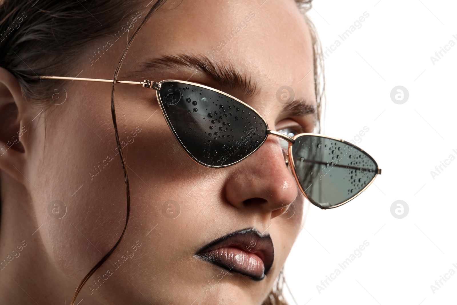 Beautiful young woman with black lip liner wearing wet sunglasses on white background, closeup Photo of Beautiful young woman with black lip liner wearing wet sunglasses on white background, closeup