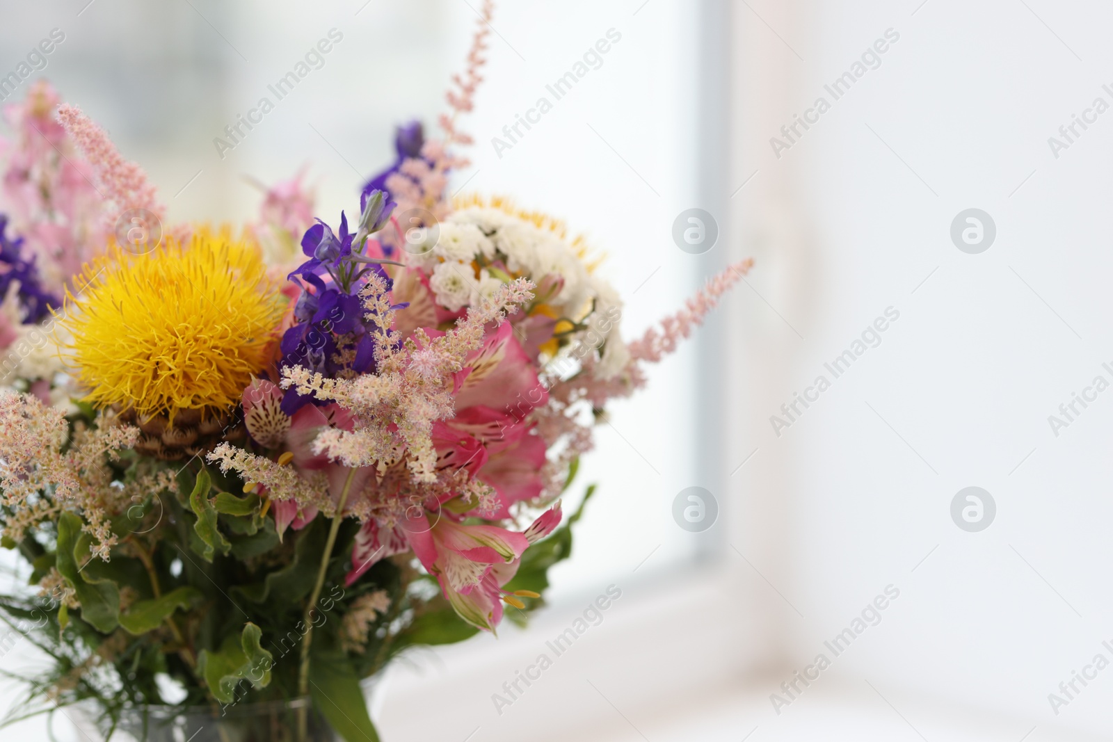 Bouquet of beautiful flowers on windowsill indoors, closeup. Space for text Photo of Bouquet of beautiful flowers on windowsill indoors, closeup. Space for text