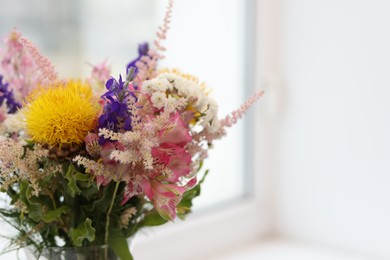 Photo of Bouquet of beautiful flowers on windowsill indoors, closeup. Space for text