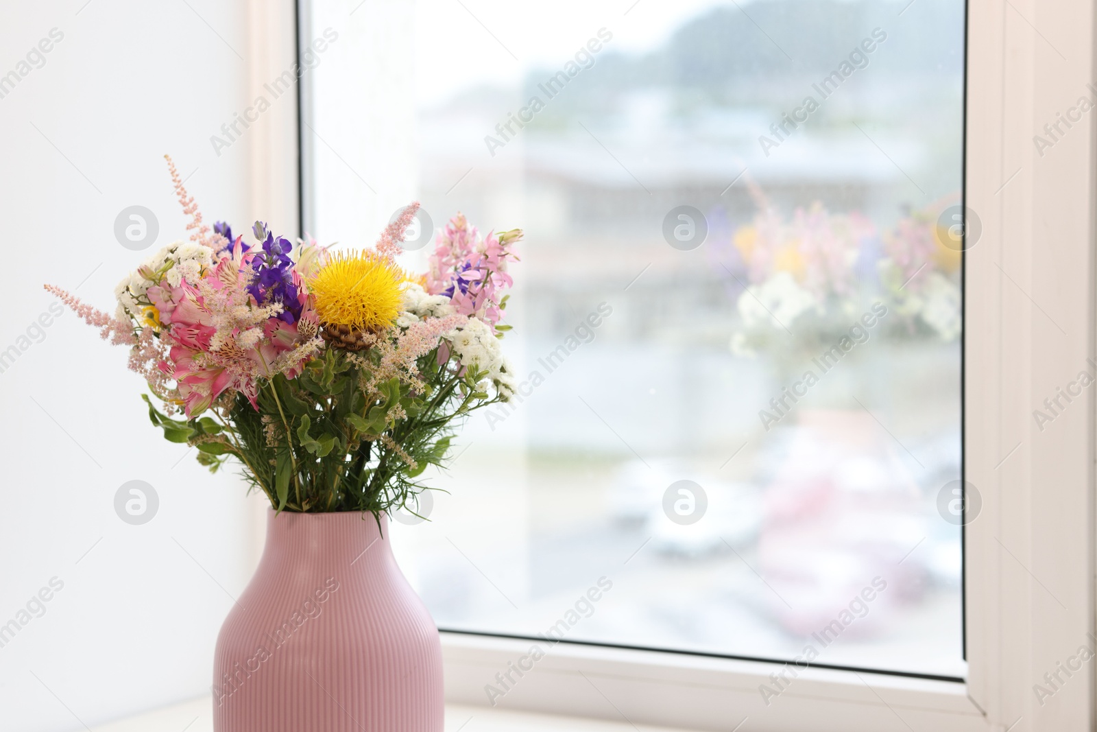 Bouquet of beautiful flowers on windowsill indoors, closeup. Space for text Photo of Bouquet of beautiful flowers on windowsill indoors, closeup. Space for text