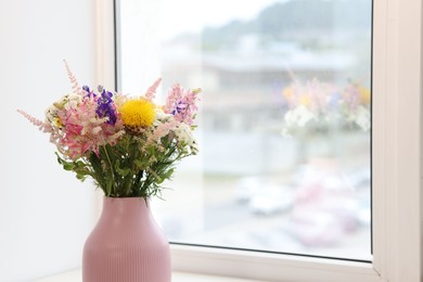 Photo of Bouquet of beautiful flowers on windowsill indoors, closeup. Space for text