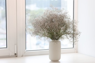 Photo of Bouquet of beautiful flowers on windowsill indoors, space for text