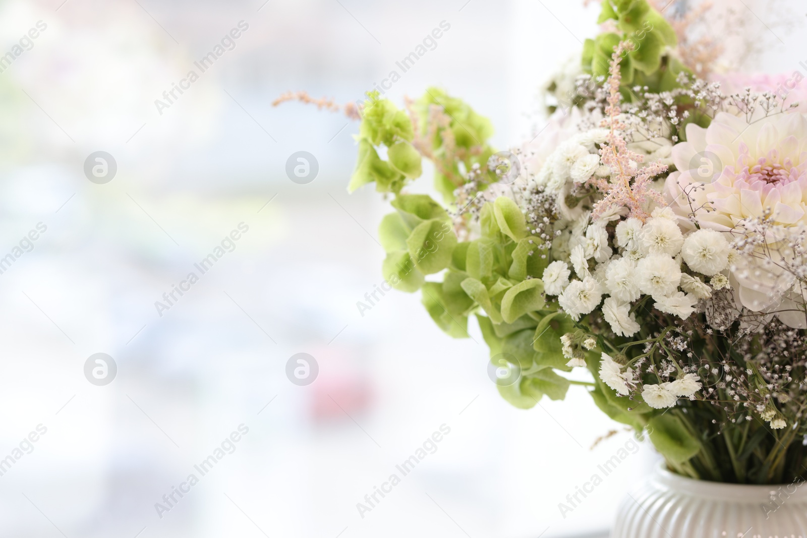 Photo of Bouquet of beautiful flowers on windowsill indoors, closeup. Space for text