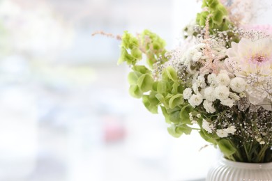Photo of Bouquet of beautiful flowers on windowsill indoors, closeup. Space for text