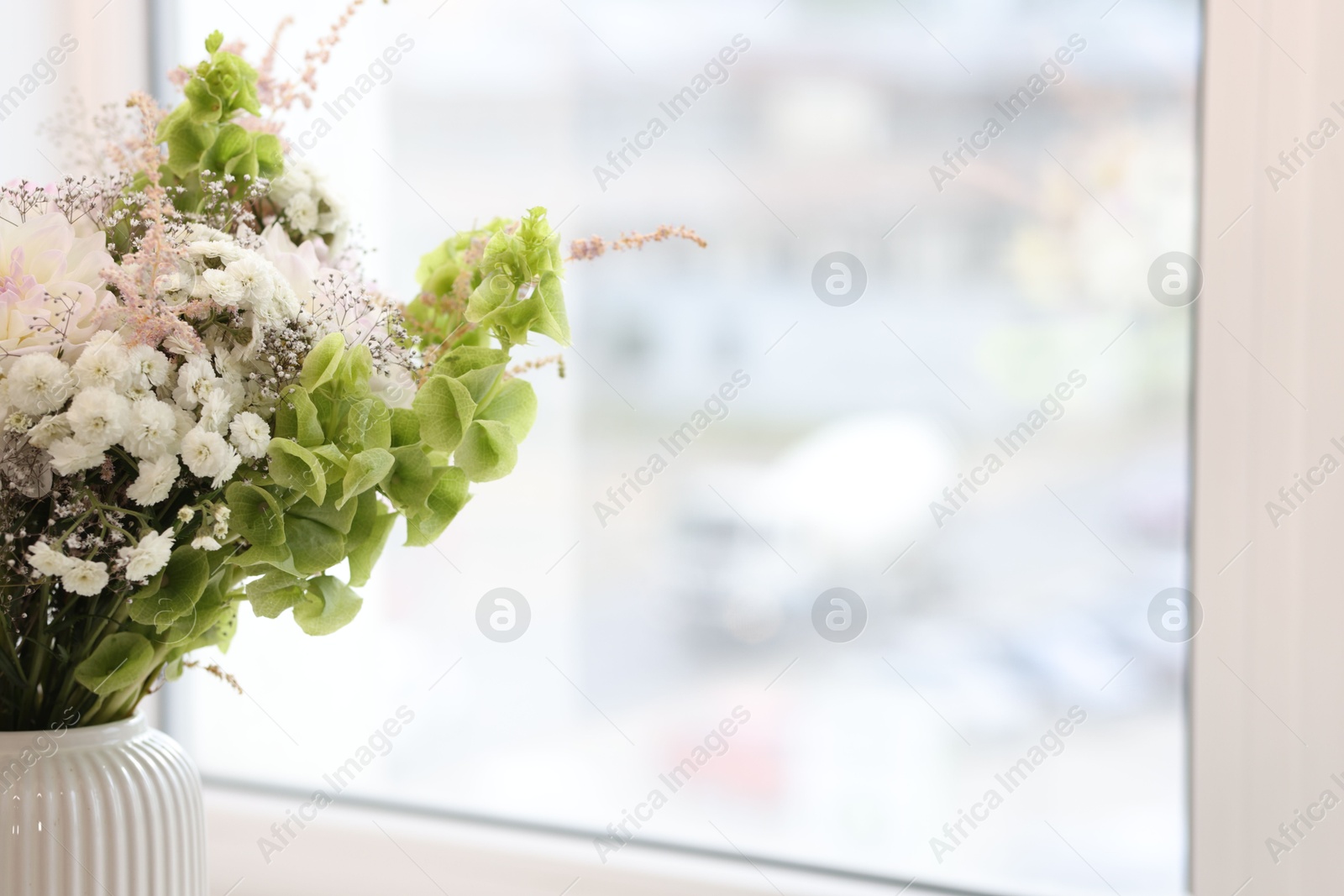 Bouquet of beautiful flowers on windowsill indoors, closeup. Space for text Photo of Bouquet of beautiful flowers on windowsill indoors, closeup. Space for text