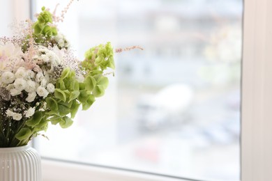 Photo of Bouquet of beautiful flowers on windowsill indoors, closeup. Space for text
