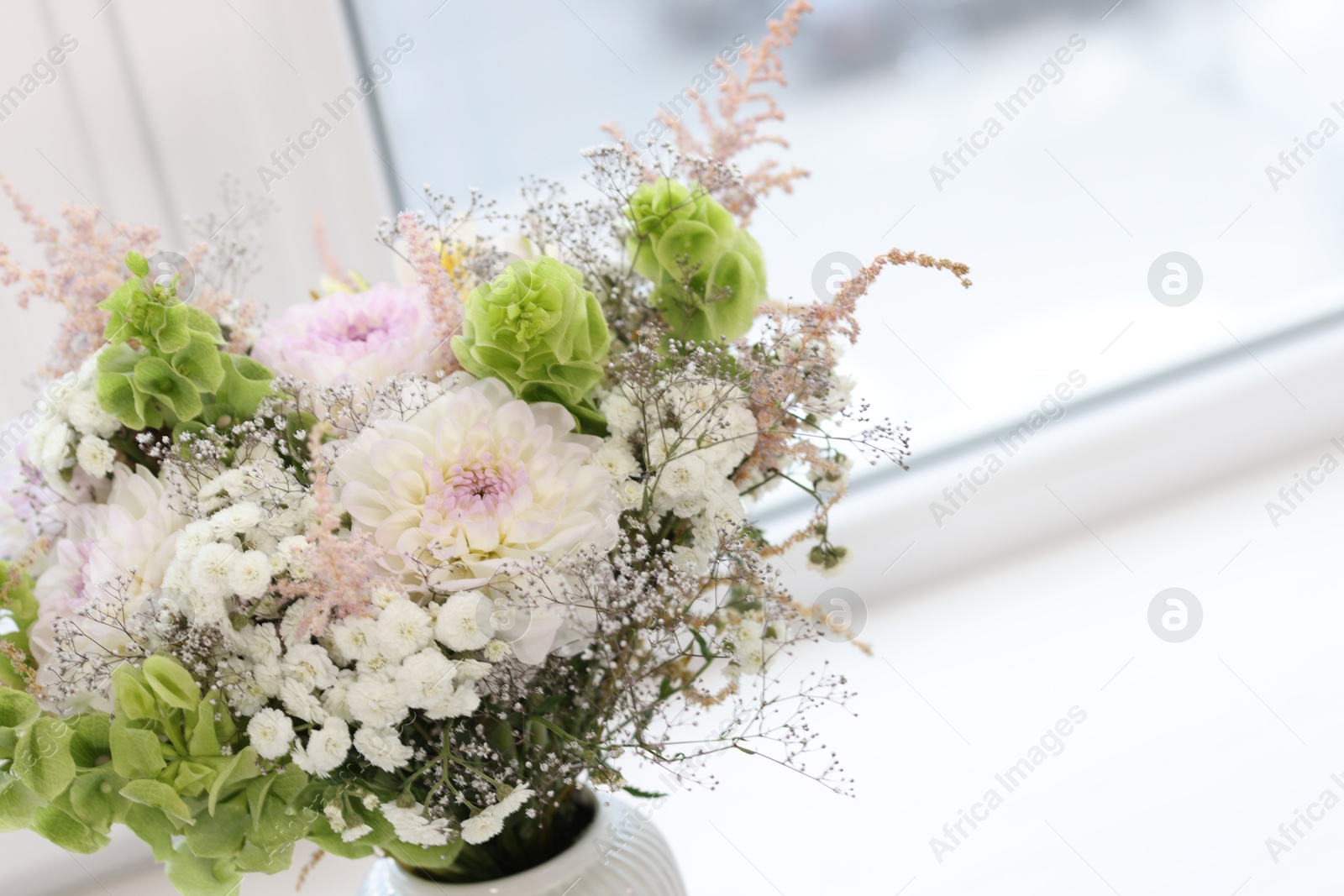 Bouquet of beautiful flowers on windowsill indoors, closeup. Space for text Photo of Bouquet of beautiful flowers on windowsill indoors, closeup. Space for text