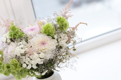 Photo of Bouquet of beautiful flowers on windowsill indoors, closeup. Space for text