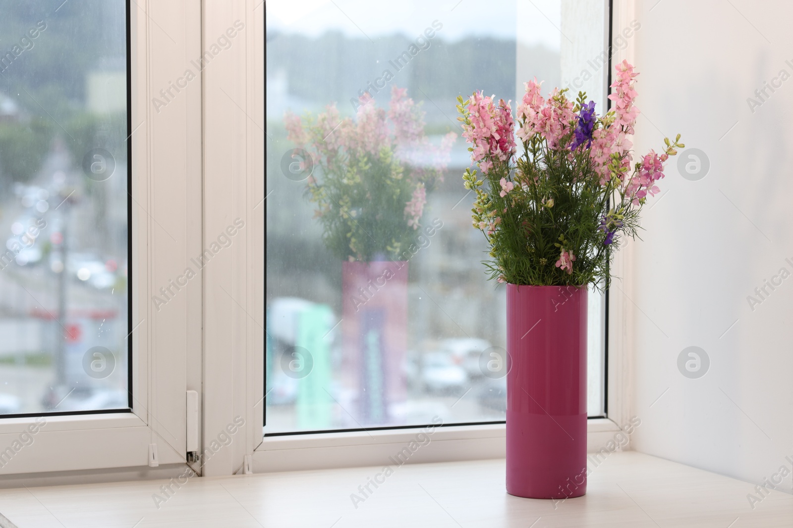 Bouquet of beautiful flowers on windowsill indoors, space for text Photo of Bouquet of beautiful flowers on windowsill indoors, space for text