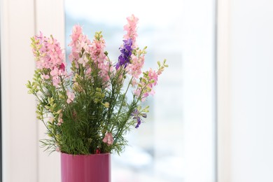 Photo of Bouquet of beautiful flowers on windowsill indoors, closeup. Space for text