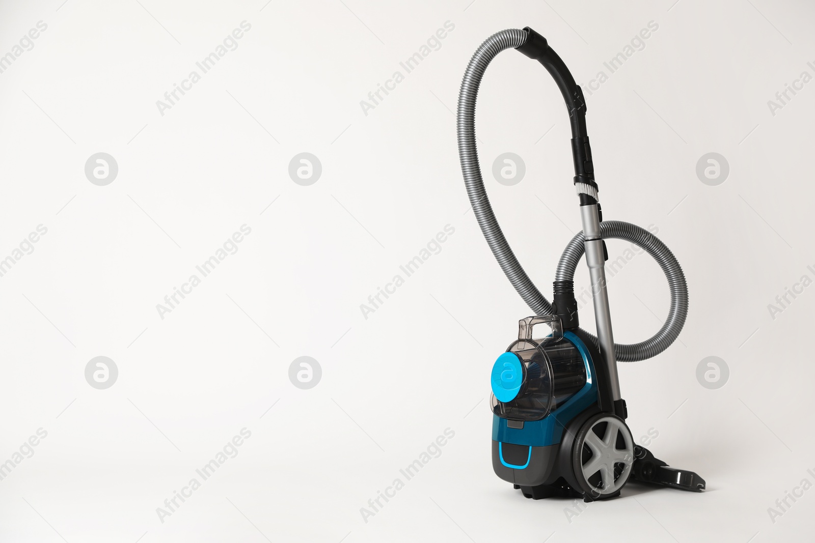 One vacuum cleaner on light grey background. Space for text Photo of One vacuum cleaner on light grey background. Space for text