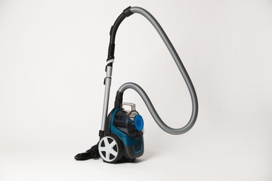 Photo of One vacuum cleaner on light grey background