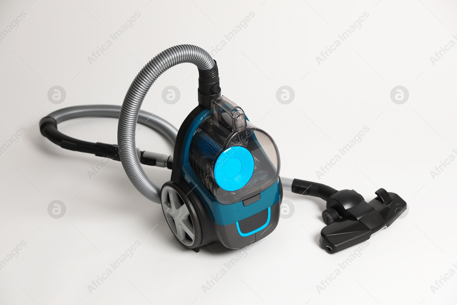 One vacuum cleaner on light grey background Photo of One vacuum cleaner on light grey background