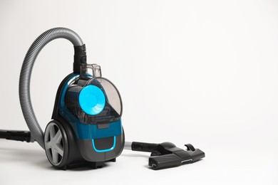 Photo of One vacuum cleaner on light grey background. Space for text