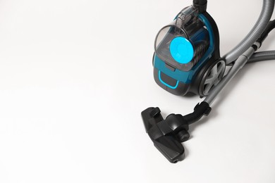 Photo of One vacuum cleaner on light grey background. Space for text