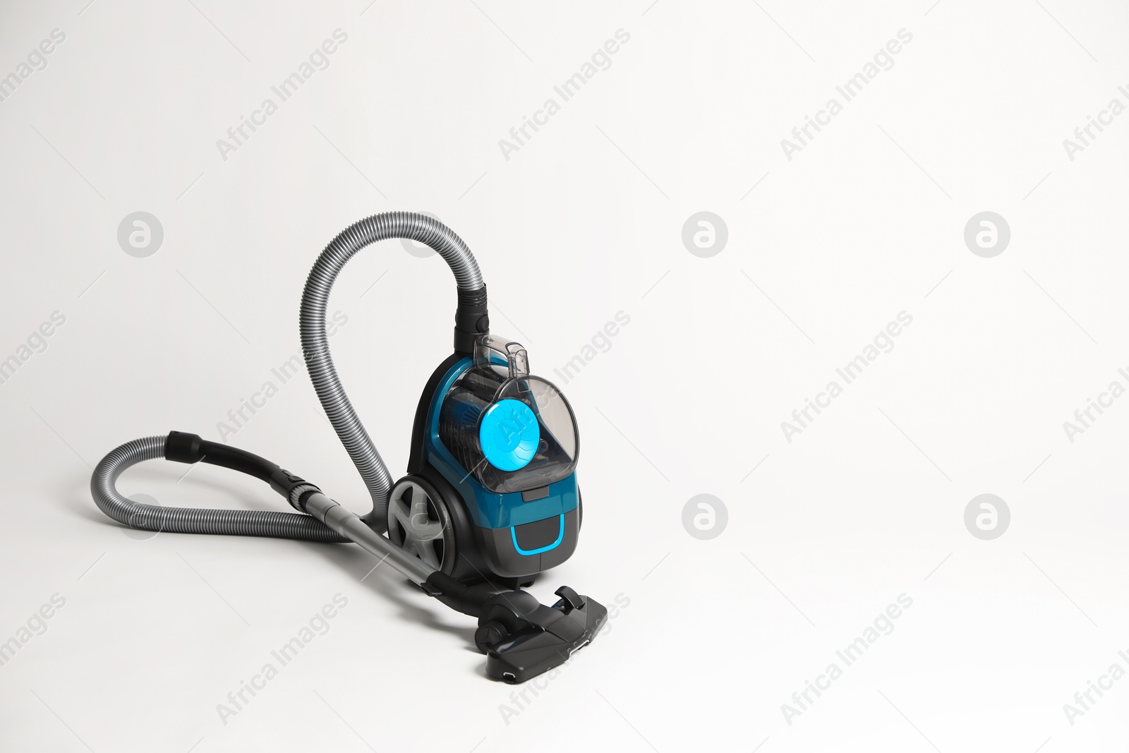 One vacuum cleaner on light grey background. Space for text Photo of One vacuum cleaner on light grey background. Space for text