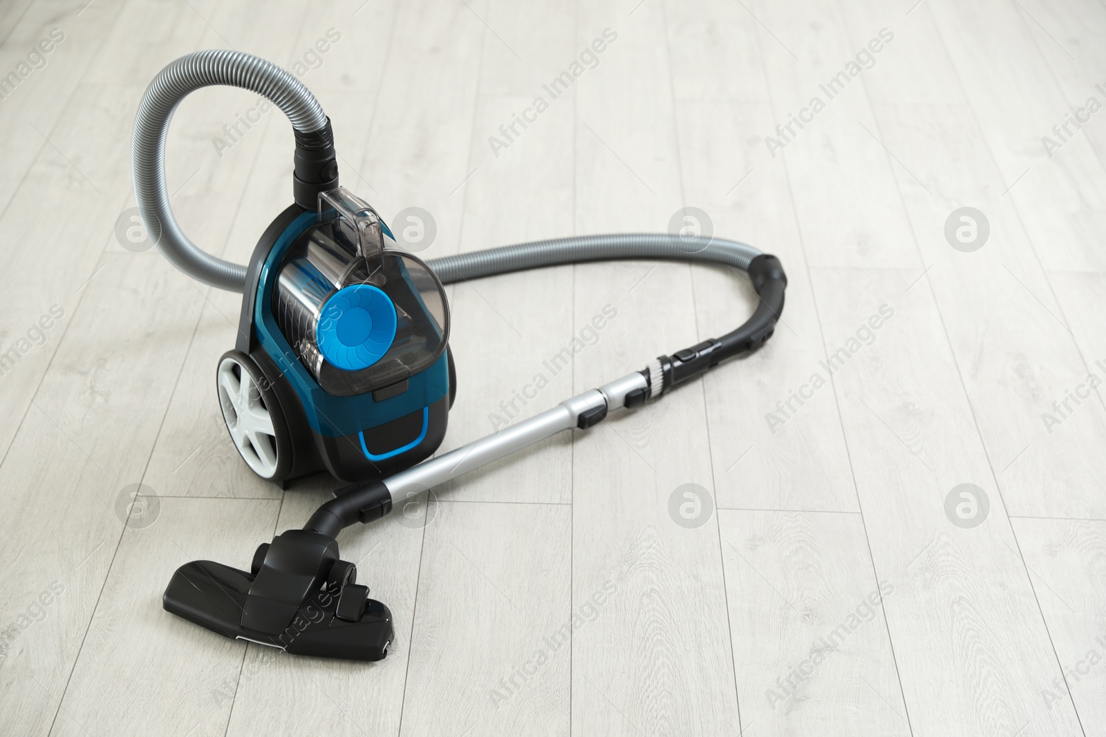 One vacuum cleaner on wooden floor. Household appliance Photo of One vacuum cleaner on wooden floor. Household appliance