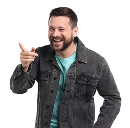Photo of Handsome man laughing and pointing at something on white background. Positive emotion