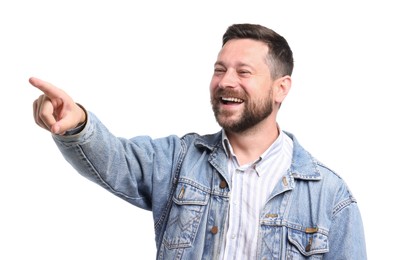 Photo of Handsome man laughing and pointing at something on white background. Positive emotion