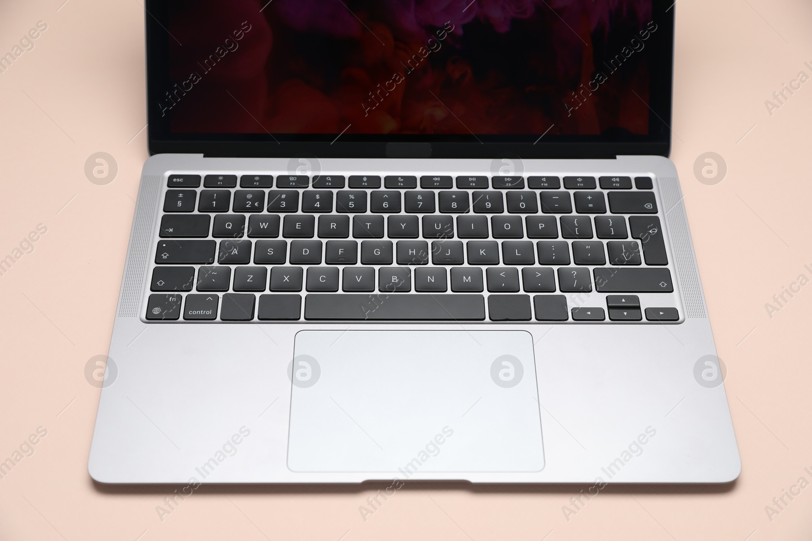 Modern laptop with keyboard on beige background, closeup Photo of Modern laptop with keyboard on beige background, closeup