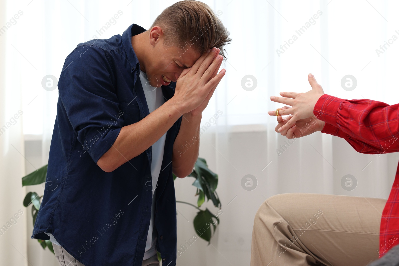 Woman taking off engagement ring after her husband's betrayal indoors, closeup Photo of Woman taking off engagement ring after her husband's betrayal indoors, closeup