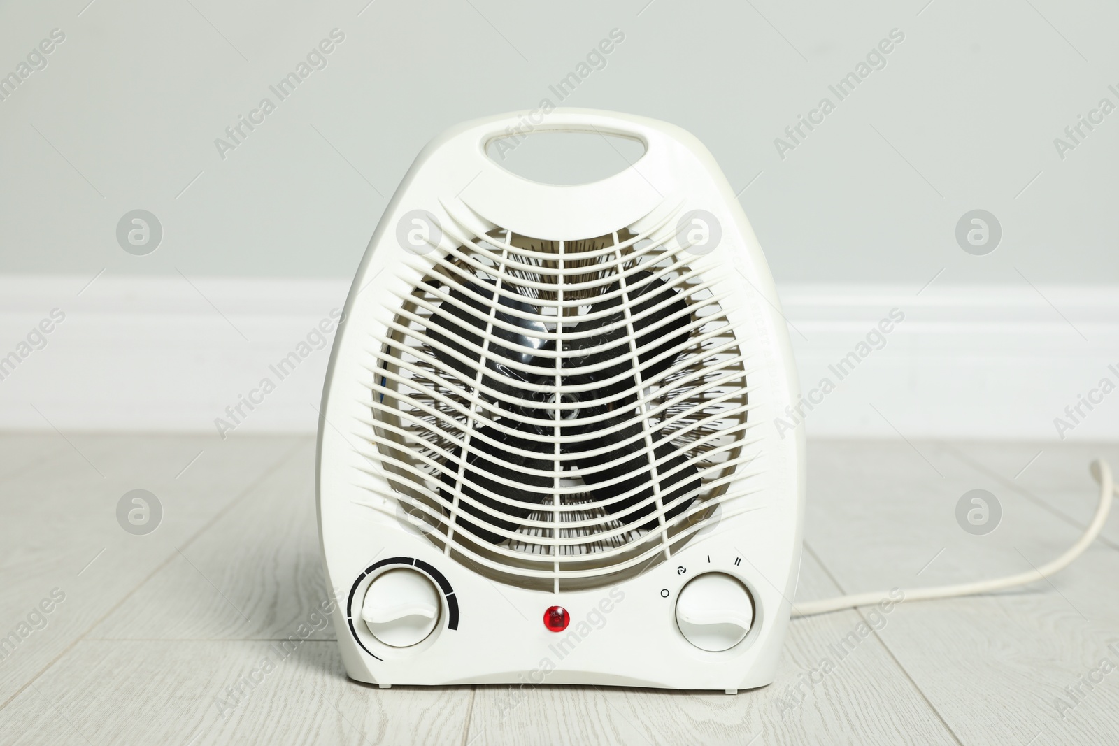 Modern electric fan heater on floor in room Photo of Modern electric fan heater on floor in room
