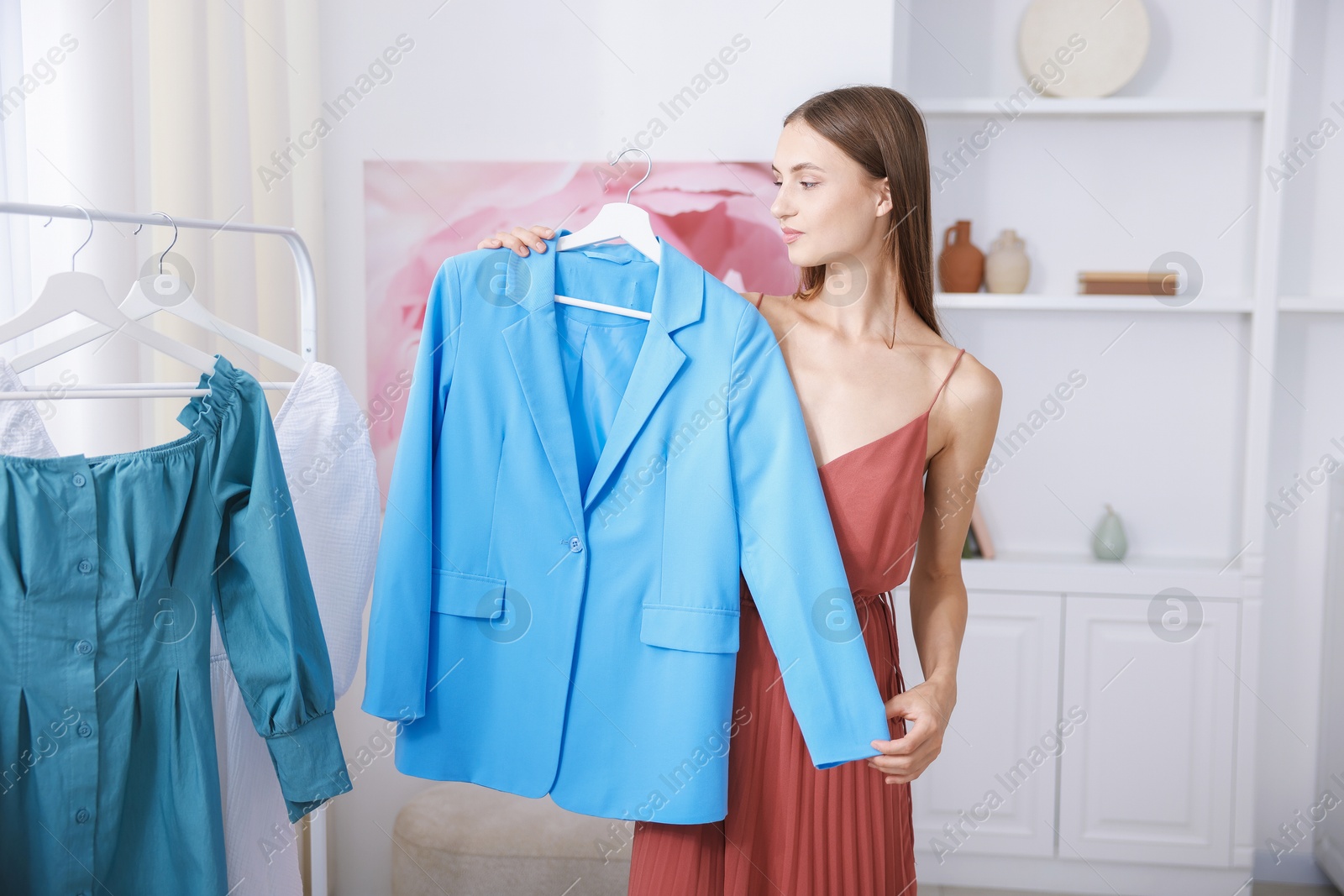 Getting ready. Young woman choosing clothes at home Photo of Getting ready. Young woman choosing clothes at home