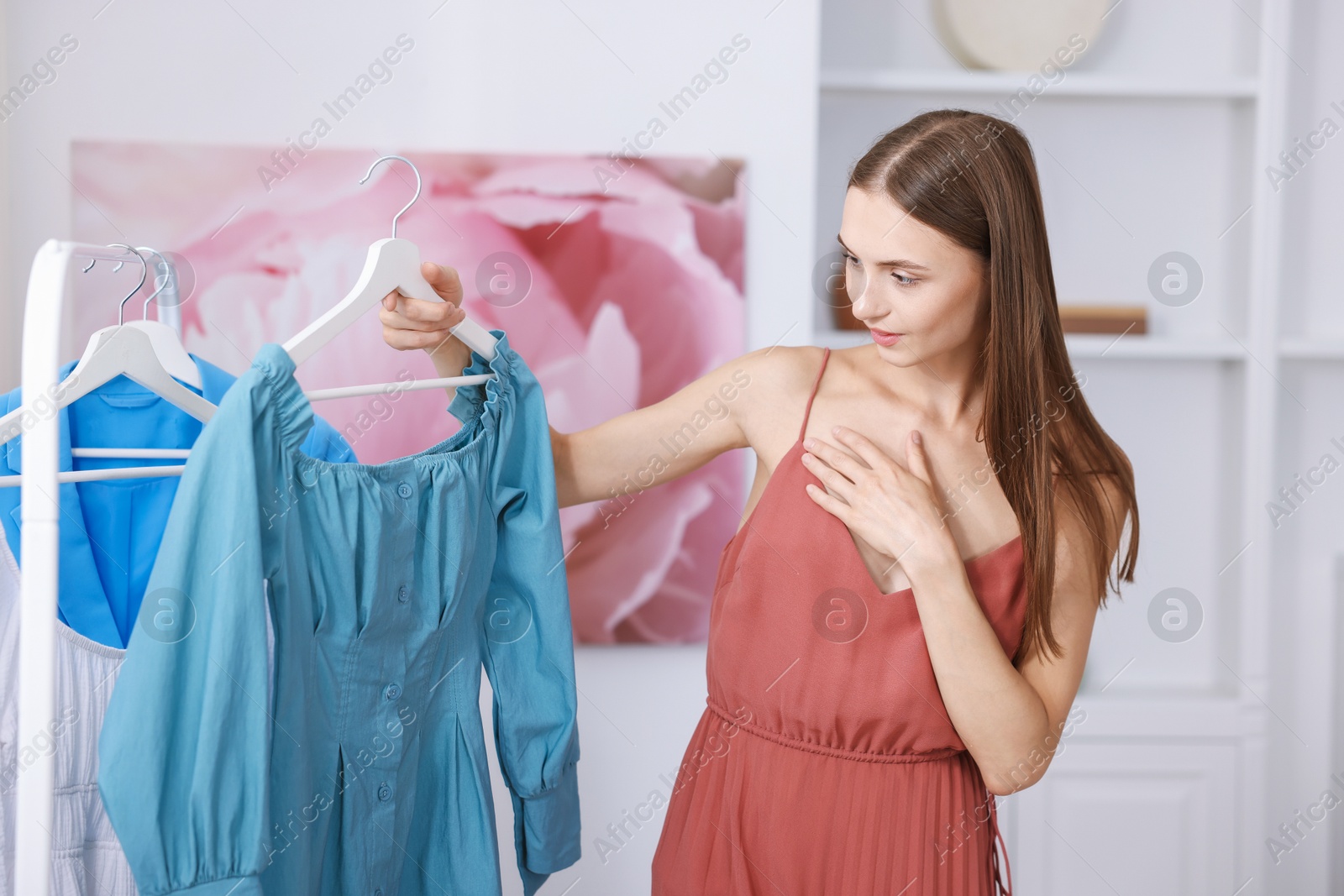 Getting ready. Young woman choosing clothes at home Photo of Getting ready. Young woman choosing clothes at home