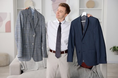 Photo of Getting ready. Young man choosing clothes at home