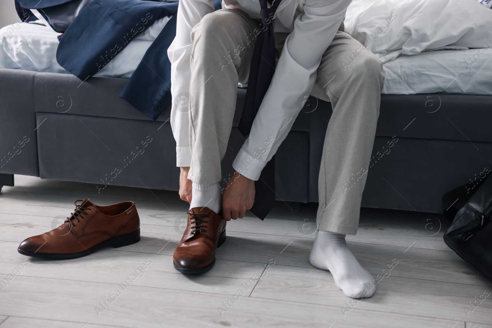 Getting ready. Young man putting on stylish shoes at home, closeup Photo of Getting ready. Young man putting on stylish shoes at home, closeup