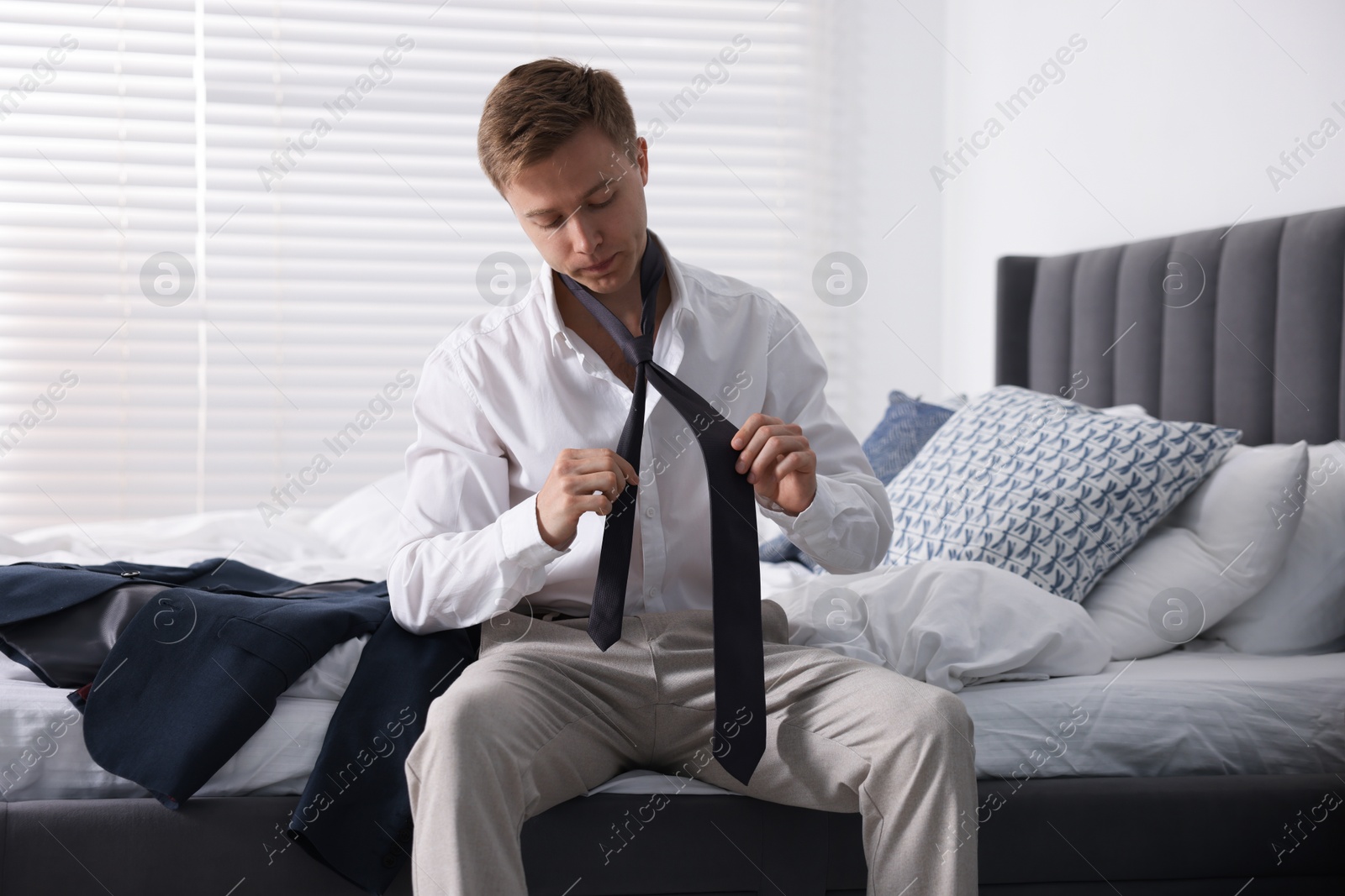 Sad young man getting ready at home Photo of Sad young man getting ready at home