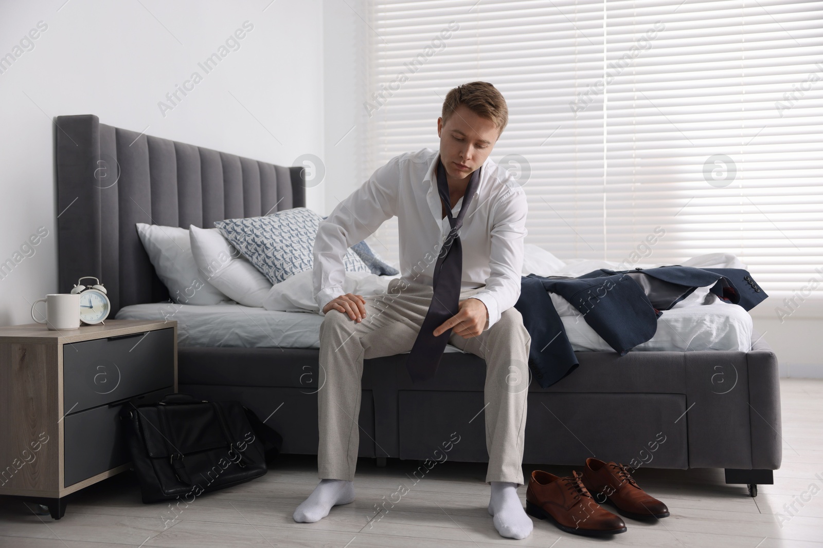 Sad young man getting ready at home Photo of Sad young man getting ready at home