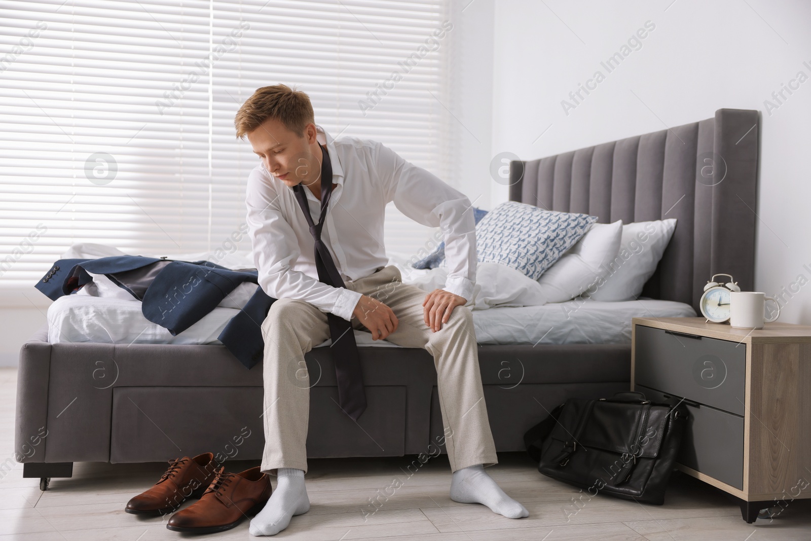 Sad young man getting ready at home Photo of Sad young man getting ready at home