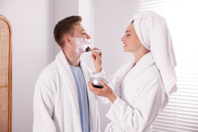 Photo of Young couple getting ready together at home
