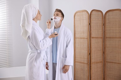 Photo of Young couple getting ready together at home