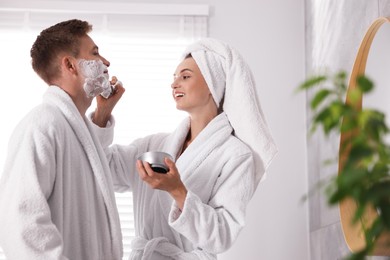 Photo of Young couple getting ready together at home