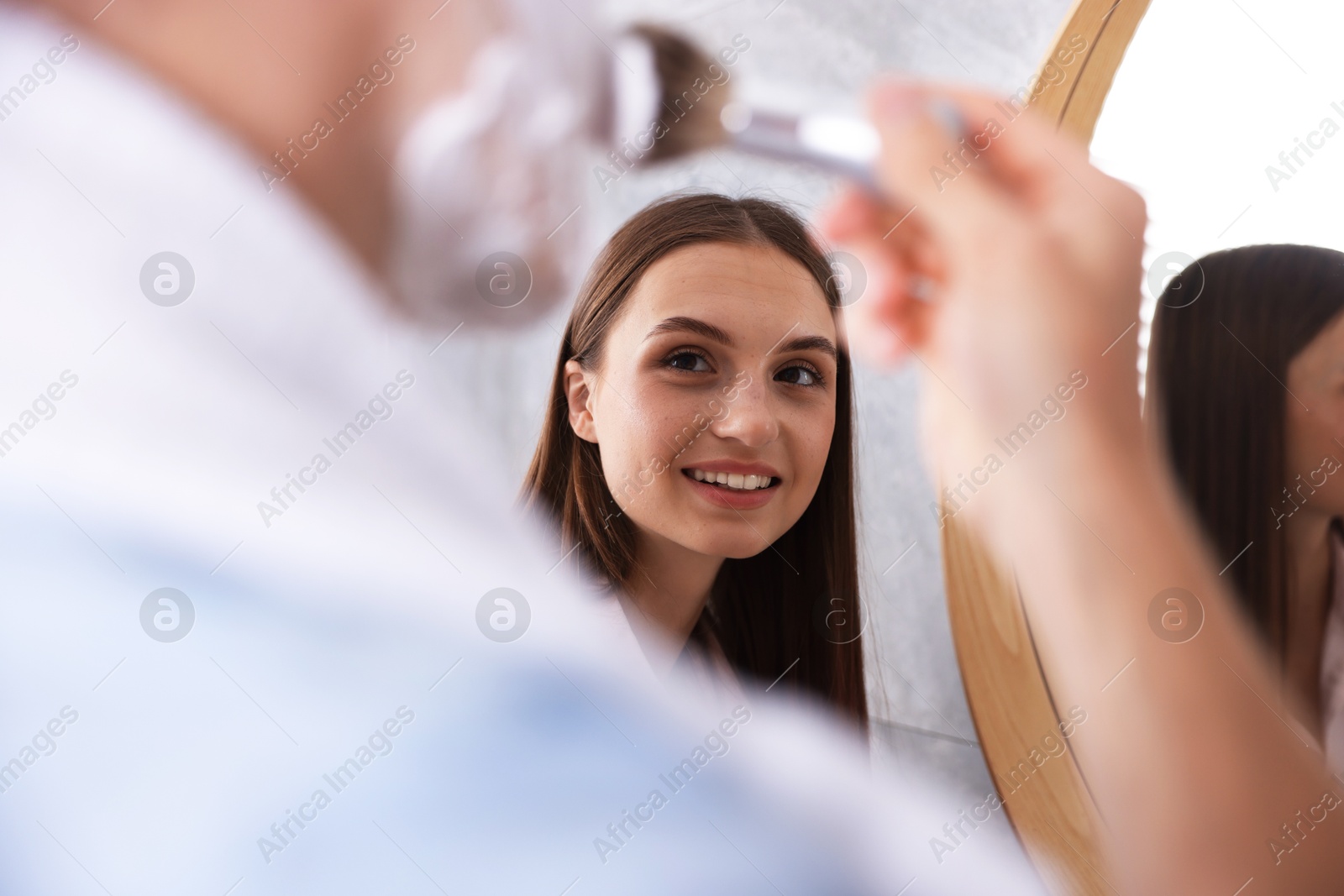 Young couple getting ready together near mirror at home Photo of Young couple getting ready together near mirror at home