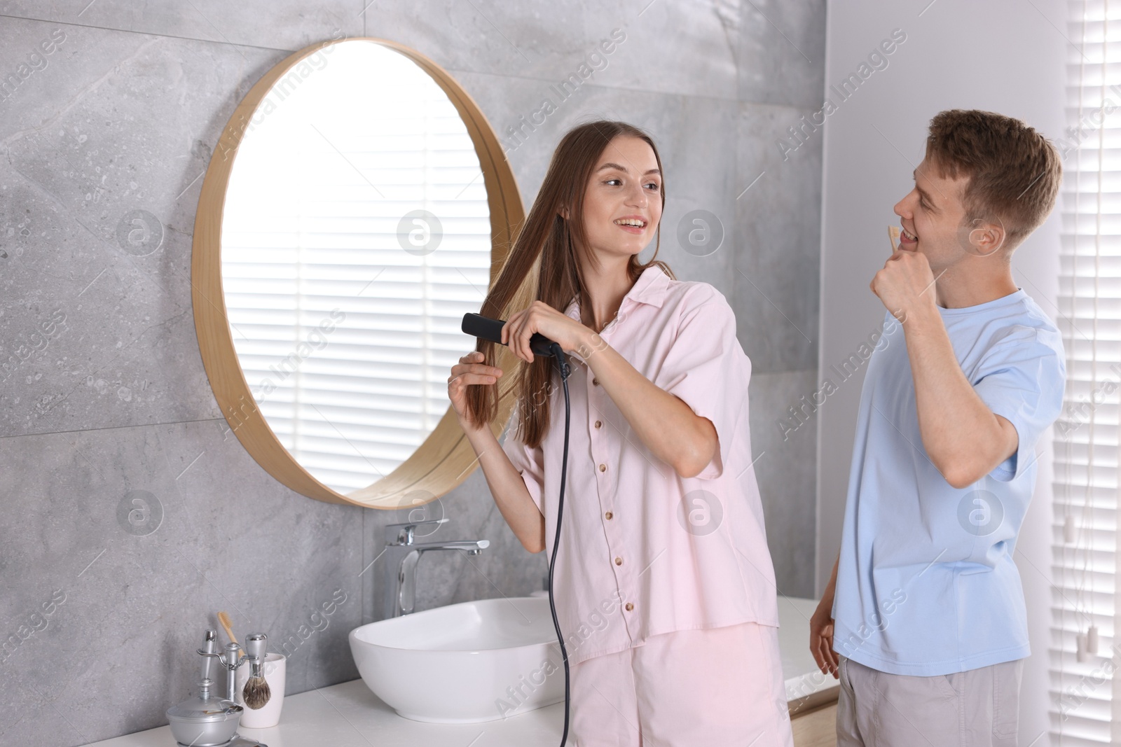 Young couple getting ready together near mirror at home Photo of Young couple getting ready together near mirror at home