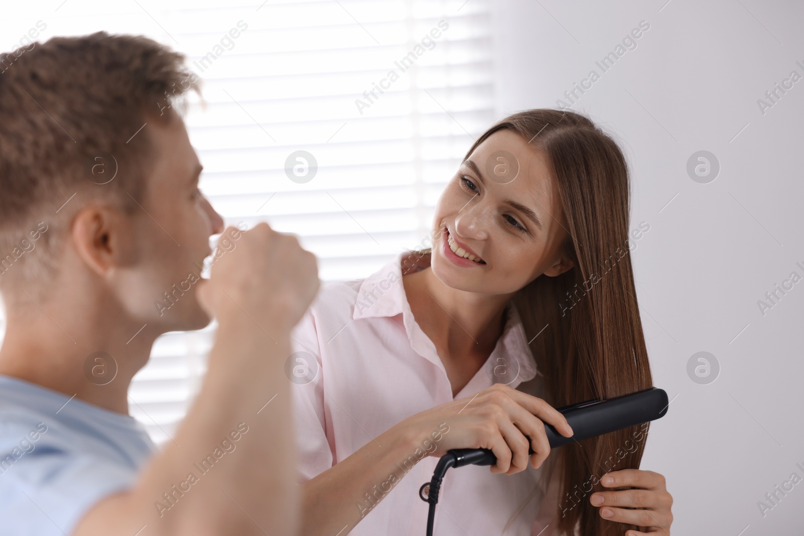 Young couple getting ready together near mirror at home Photo of Young couple getting ready together near mirror at home
