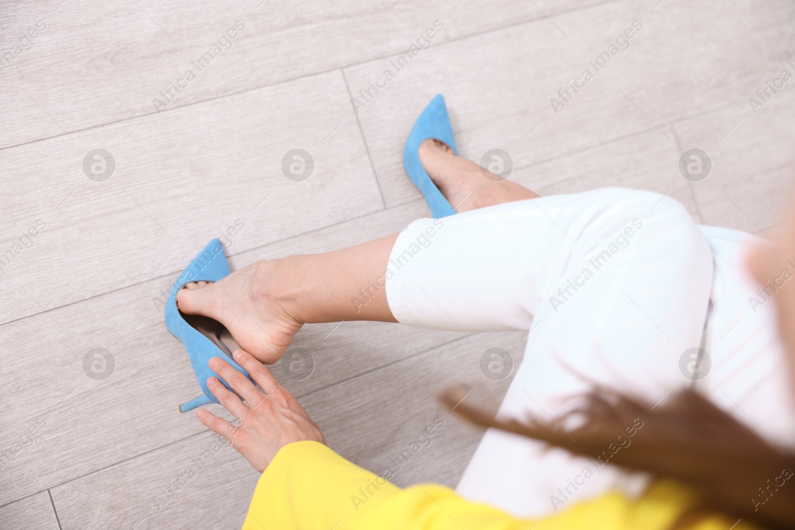 Getting ready. Young woman putting on high heeled shoes at home, closeup Photo of Getting ready. Young woman putting on high heeled shoes at home, closeup