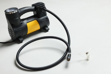 Photo of One modern tire inflator on light background