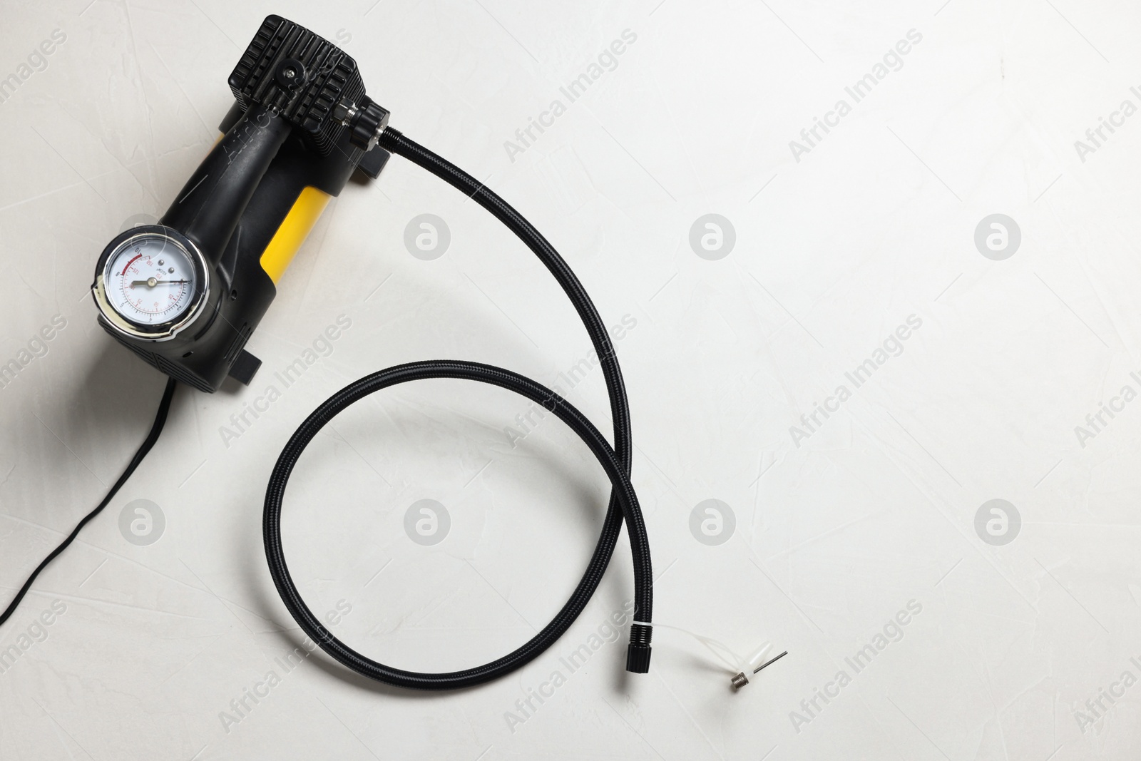 One tire inflator on light background, top view. Space for text Photo of One tire inflator on light background, top view. Space for text