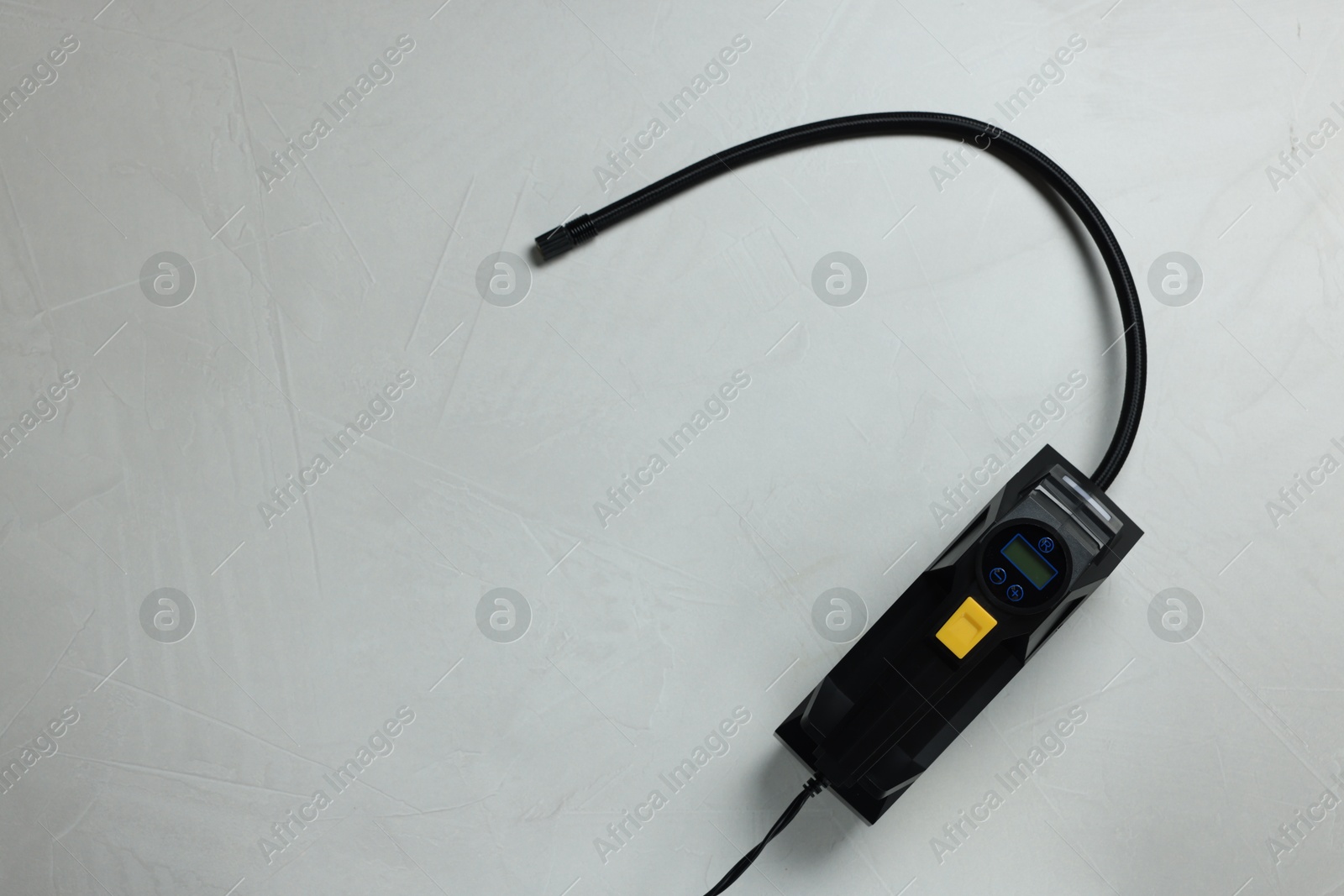 One tire inflator on light background, top view. Space for text Photo of One tire inflator on light background, top view. Space for text