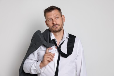 Photo of Man suffering from hangover on white background