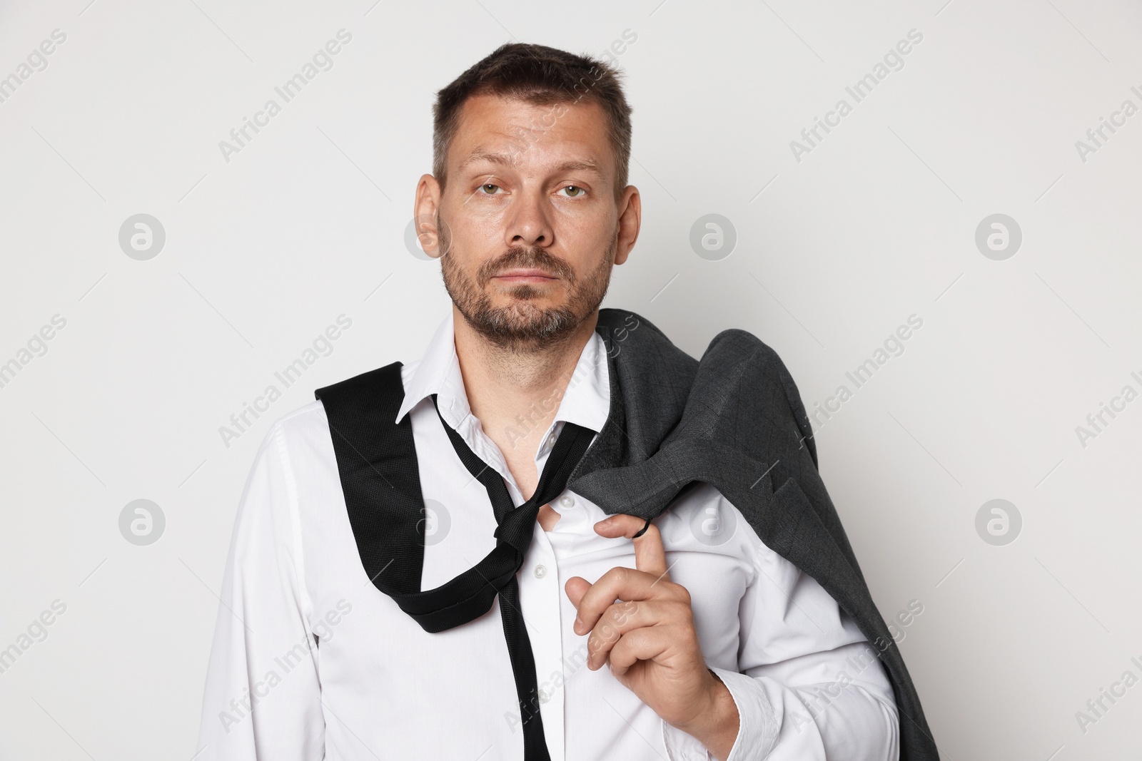 Man suffering from hangover on white background Photo of Man suffering from hangover on white background