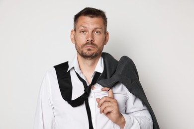 Photo of Man suffering from hangover on white background