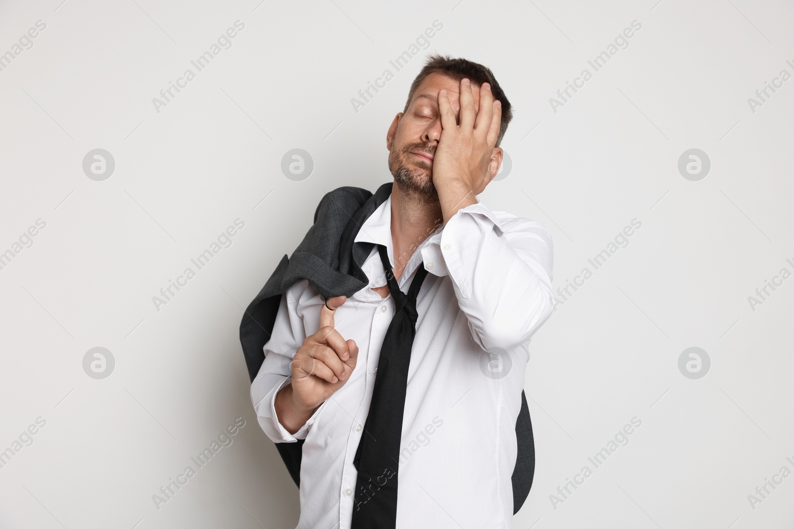 Photo of Man suffering from hangover on white background