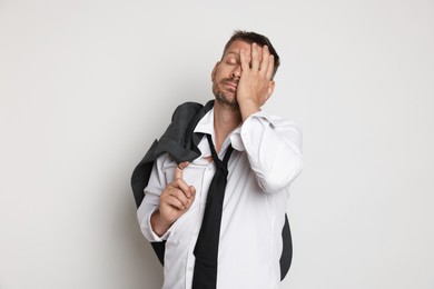 Photo of Man suffering from hangover on white background
